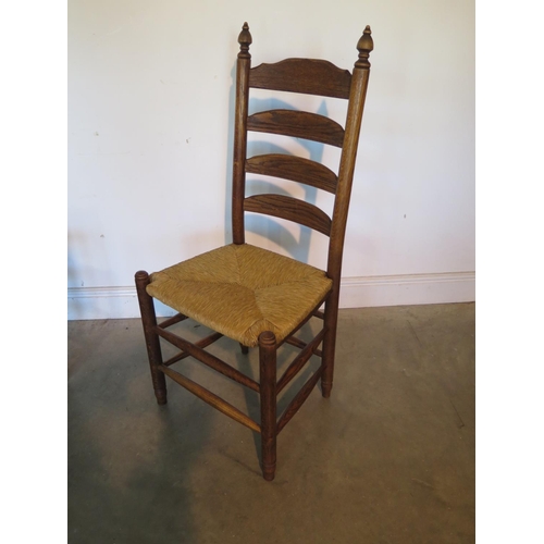 40 - As set of four oak ladder back dining chairs with rush seats, all in sturdy condition