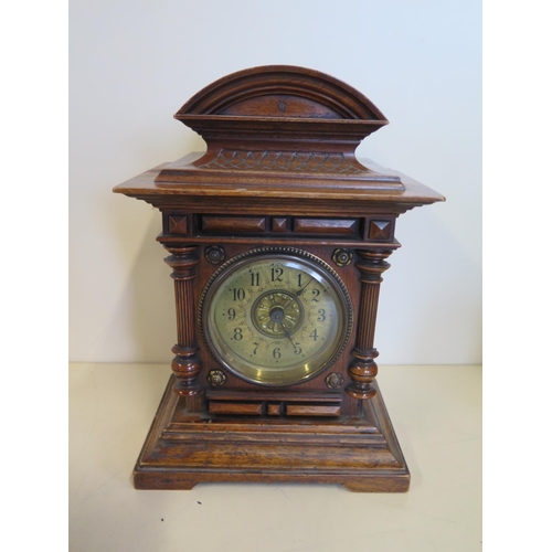 404 - A small walnut Junghams mantle clock 23cm tall, some wear to case but running