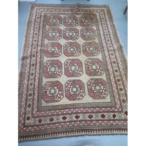 455 - A woollen cream ground rug, decorated with geometric shapes, approx 300cm x 203cm - in decent genera... 