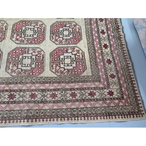 455 - A woollen cream ground rug, decorated with geometric shapes, approx 300cm x 203cm - in decent genera... 