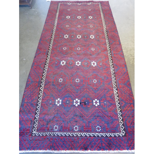 459 - A hand knotted woollen Baluchi rug 280cm x 124cm -in good condition