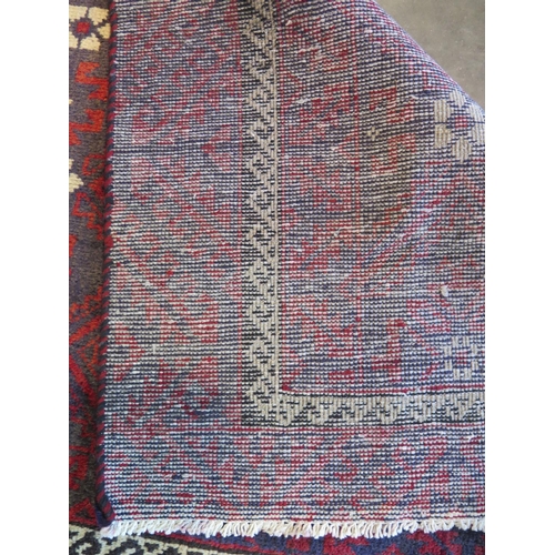 459 - A hand knotted woollen Baluchi rug 280cm x 124cm -in good condition