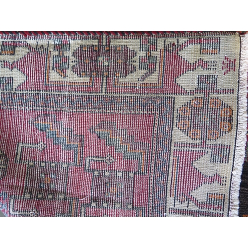 460 - A hand knotted woollen Baluchi rug - 300cm x 143cm - in good condition