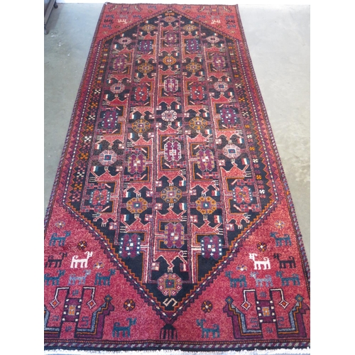 461 - A hand knotted woollen Baluchi rug 274cm x 122cm - in good condition