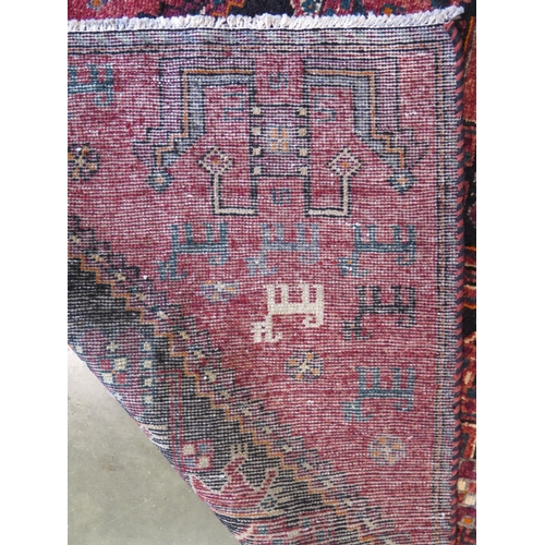 461 - A hand knotted woollen Baluchi rug 274cm x 122cm - in good condition