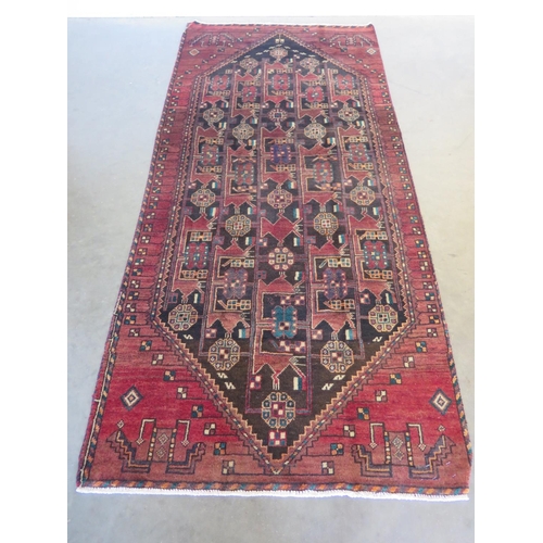 463 - A hand knotted woollen Baluchi rug 246cm x 106cm - in good condition