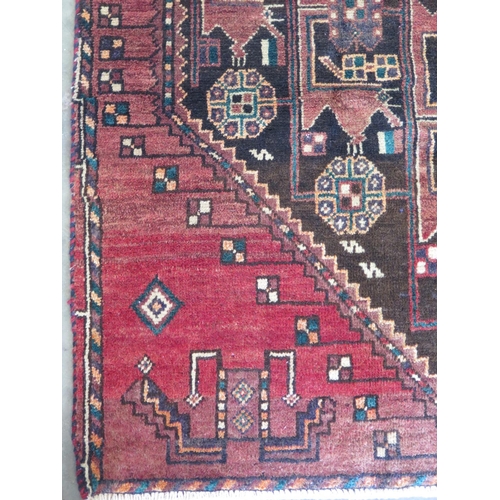 463 - A hand knotted woollen Baluchi rug 246cm x 106cm - in good condition