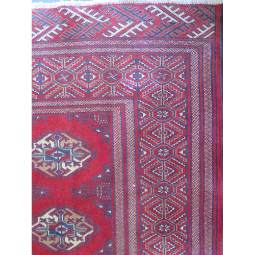 465 - A hand knotted woollen Baluchi rug 287cm x 200cm - good condition but some wear to middle