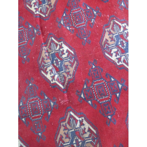 465 - A hand knotted woollen Baluchi rug 287cm x 200cm - good condition but some wear to middle