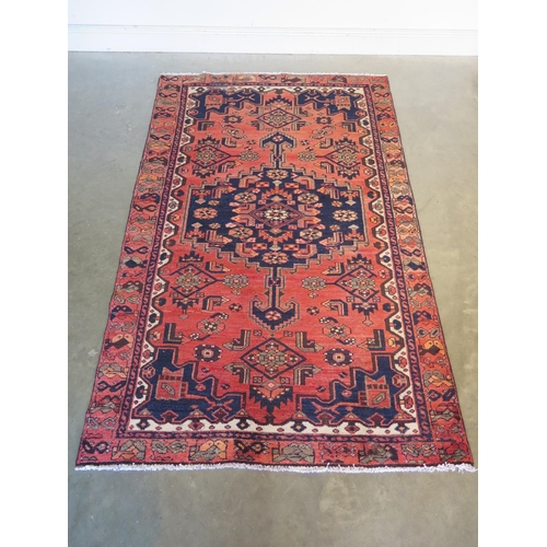 469 - A Hamadan red ground hand knotted woollen rug approx 206cm x 126cm - overall in good condition but w... 