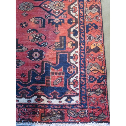 469 - A Hamadan red ground hand knotted woollen rug approx 206cm x 126cm - overall in good condition but w... 