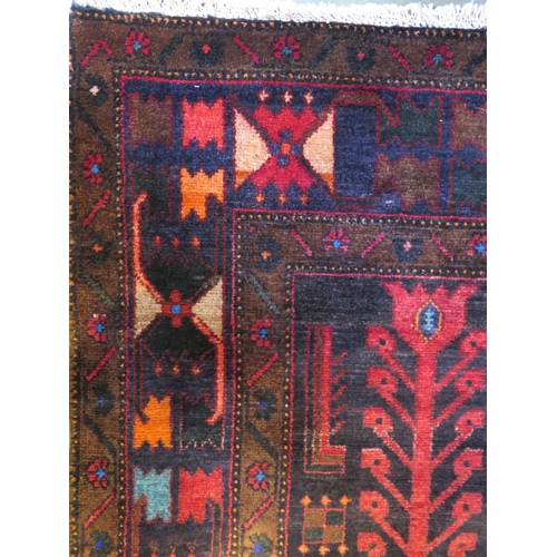 470 - A Baluchi red ground hand woven woollen rug, approx 336cm x 160cm - in general good condition but wi... 