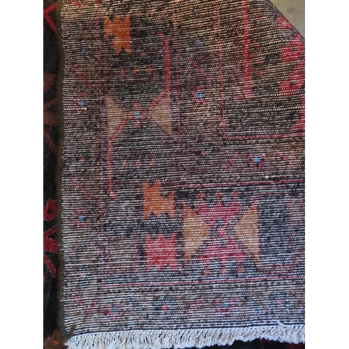 470 - A Baluchi red ground hand woven woollen rug, approx 336cm x 160cm - in general good condition but wi... 