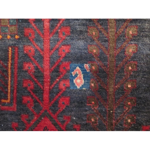 470 - A Baluchi red ground hand woven woollen rug, approx 336cm x 160cm - in general good condition but wi... 