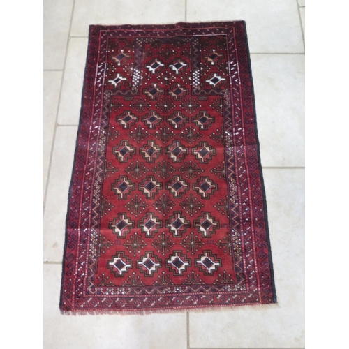 475 - A hand knotted woollen Old Baluchi runner - 138cm x 83cm