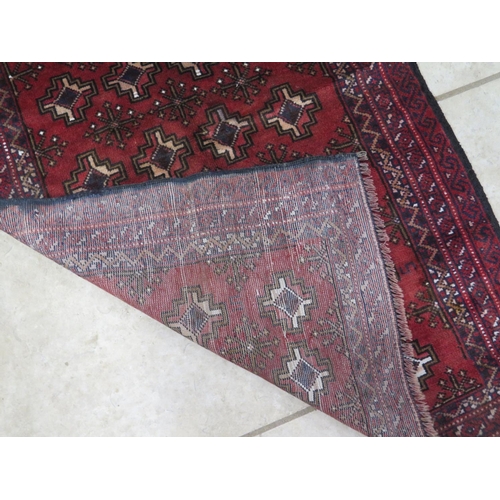 475 - A hand knotted woollen Old Baluchi runner - 138cm x 83cm