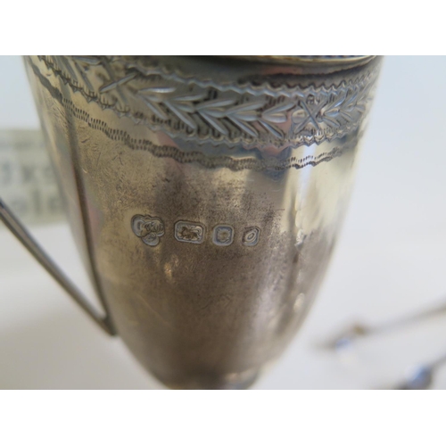 553 - A silver milk jug together with six silver teaspoons, a silver pair of sugar tongs, approx 7.4 troy ... 