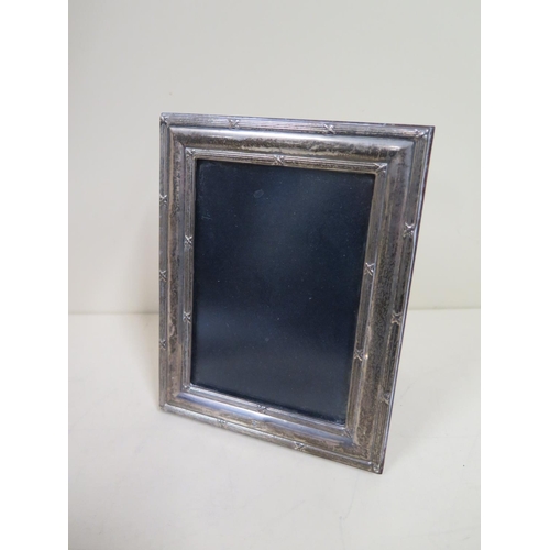 558 - A silver photograph frame with ribbed detail - 18cm x 14cm - very minor denting, but overall good