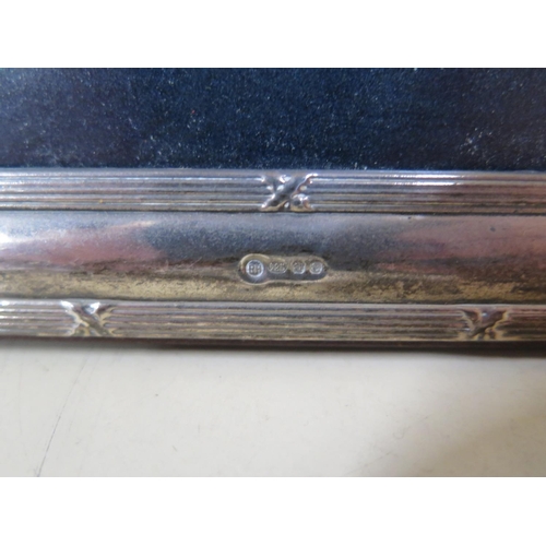 558 - A silver photograph frame with ribbed detail - 18cm x 14cm - very minor denting, but overall good