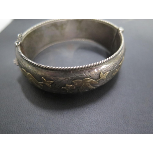 564 - A mixed silver lot consisting of a silver bangle with gold decoration, silver ladies watch, perfume ... 