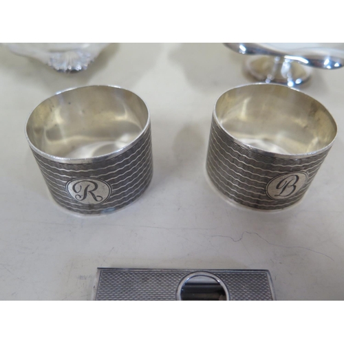 573 - A silver shell form pin dish, together with another silver pin dish, two silver napkin rings, approx... 