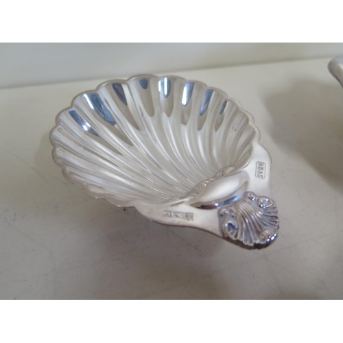 573 - A silver shell form pin dish, together with another silver pin dish, two silver napkin rings, approx... 