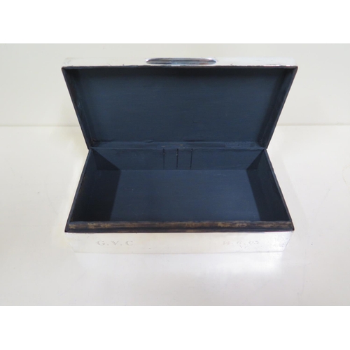 580 - A silver presentation cigarette box, 5cm x 16cm x 9cm - general wear and some dents, interior painte... 