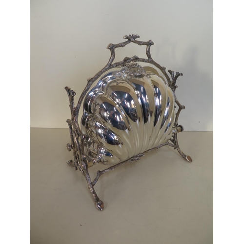 587 - A late 19th Century silver plated biscuit box in shell form with bark effect stand and gilt interior... 