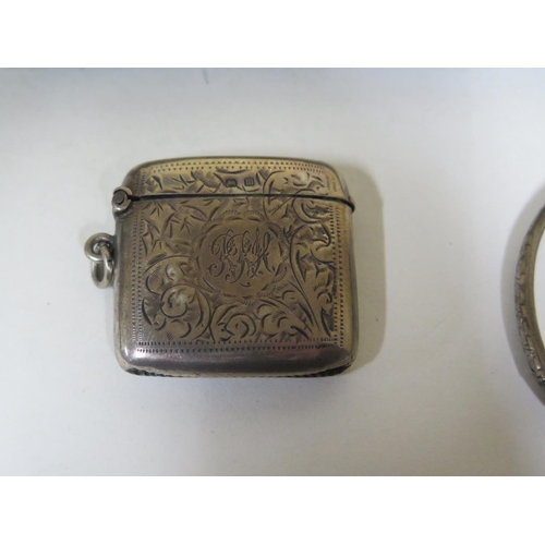 590 - A silver cigarette case, Birmingham 1906 - together with a silver Vesta case, Birmingham 1911 - and ... 