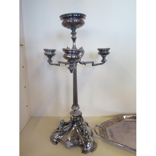 593 - A silver plated triform centrepiece 58 cm tall, and a plated tray 59cm wide, the centre piece with c... 