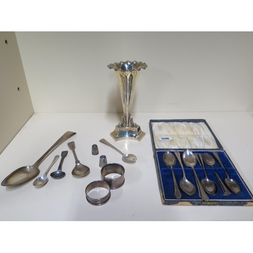 598 - A selection of silver ware including two sets of tea spoons, two thimbles, two serviette rings and a... 