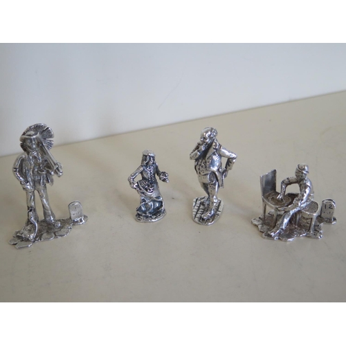 611 - A group of seven C20 silver figures, fur of which are place/menu holders and three are characters fr... 