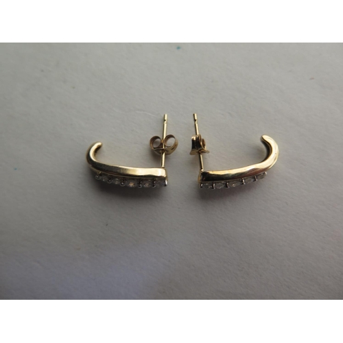 653 - A pair of 9ct hallmarked yellow gold five stone diamond earrings, 15mm long, approx two grams, total... 