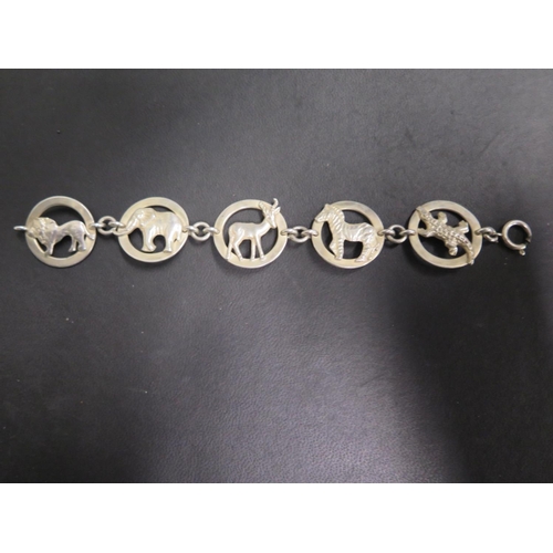 655 - A South African Krugar Park silver bracelet, made up of panels depicting different wild animals, mak... 