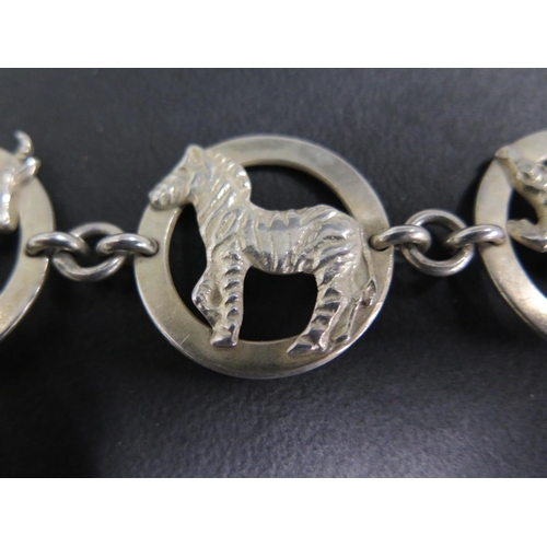 655 - A South African Krugar Park silver bracelet, made up of panels depicting different wild animals, mak... 