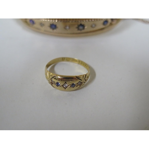 657 - A 9ct gold bangle with diamonds, a sapphire and three blue stones, approx 11.3 grams, approx 6.5cm o... 