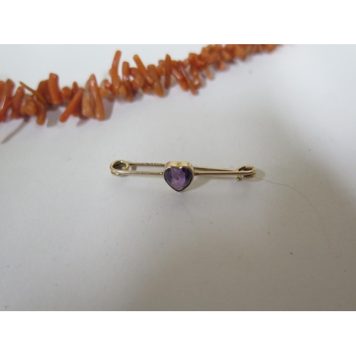 659 - A 9ct gold pin brooch with amethyst style stone, approx 1 gram, also a silver ring and coral necklac... 