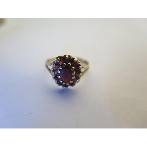 660 - A 9ct hallmarked yellow gold garnet ring, size L, approx 1.8 grams, some usage marks, consistent wit... 