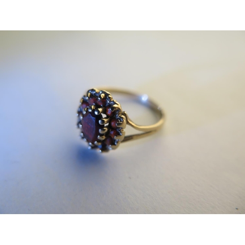 660 - A 9ct hallmarked yellow gold garnet ring, size L, approx 1.8 grams, some usage marks, consistent wit... 