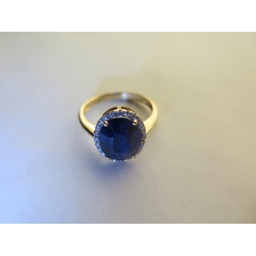 669 - A 14ct yellow gold sapphire and diamond ring, size N/O - approx 3.3 grams, sapphire approx 10mm x 8m... 