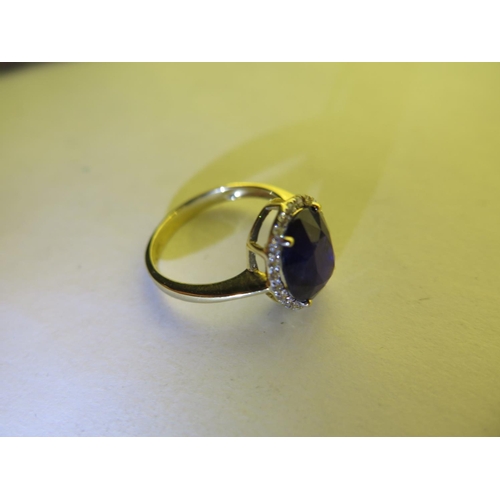 669 - A 14ct yellow gold sapphire and diamond ring, size N/O - approx 3.3 grams, sapphire approx 10mm x 8m... 