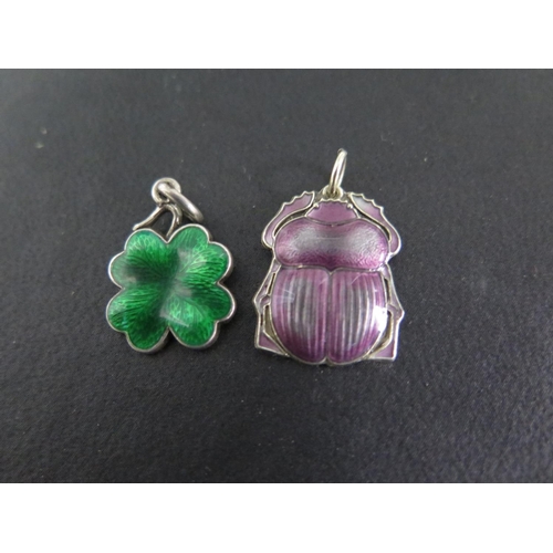 671 - Two silver enamelled pendants, one in the form of a beetle, the other a four leaf clover - beetle is... 