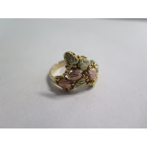 672 - A 10ct two colour gold ring with leaf decoration, ring size Q/R - approx 5.7 grams, in good conditio... 