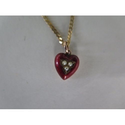 691 - A 9ct red enamelled heart pendant set with seed pearls, on 9ct chain, chain 45cm long, pendant 15mm ... 