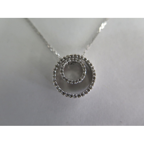 692 - A 14ct white gold circular diamond pendant on 14ct white gold chain, chain 40cm long, pendant 15mm d... 