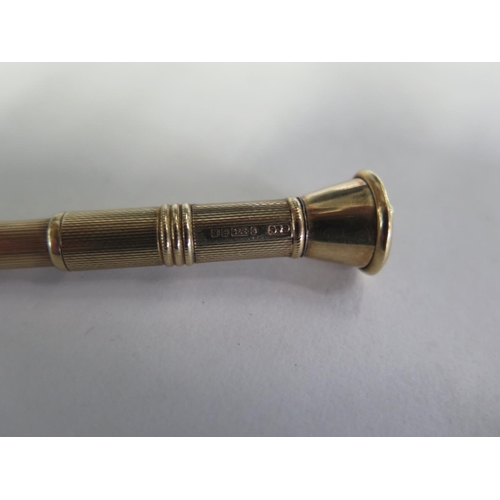 693 - A 9ct yellow gold sprung cigar prick, 7cm long, approx 8.3 grams, in good condition