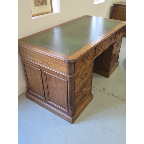 8 - A good quality antique style oak free standing pedestal desk with seven active drawers and two slide... 