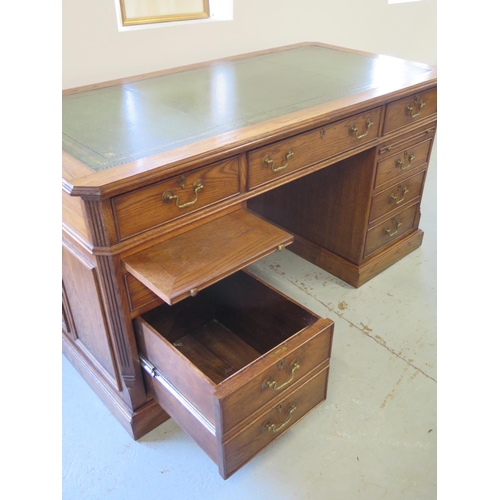 8 - A good quality antique style oak free standing pedestal desk with seven active drawers and two slide... 