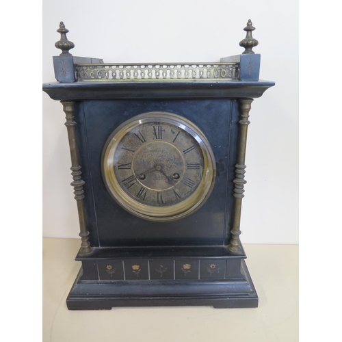 409 - A black slate mantle clock, striking in a gong - 39cm tall, with brass fittings movement stamped RC,... 