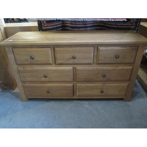 68 - A solid oak three over four chest of drawers - W140cm x D42cm x H77cm